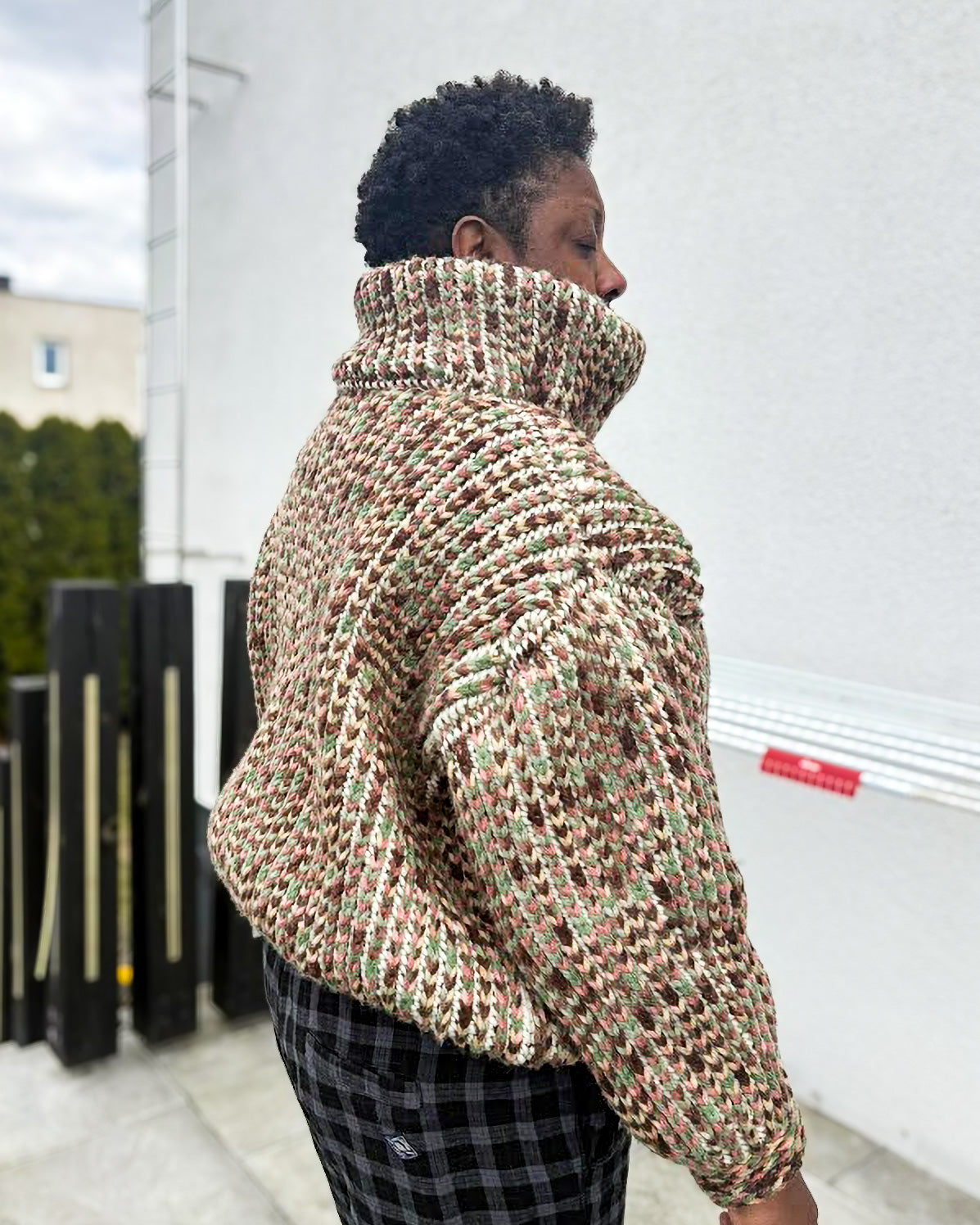 Pattern tester wearing a size Large Brioche Crochet Pullover. Back view showing the brioche column architecture and how the drop-shoulder seam lands on the arm. 