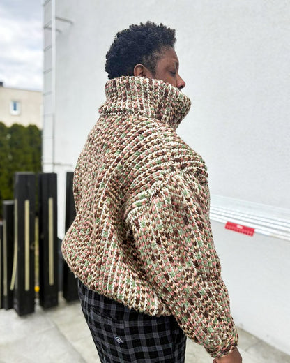 Pattern tester wearing a size Large Brioche Crochet Pullover. Back view showing the brioche column architecture and how the drop-shoulder seam lands on the arm. 
