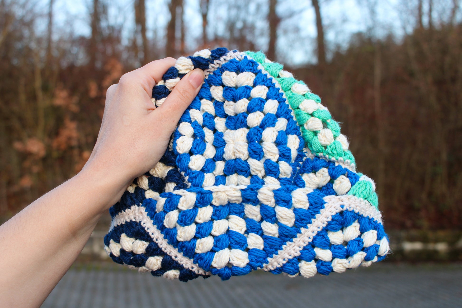 hand holding a crochet beanie