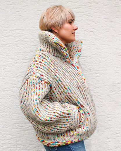 Pattern designer wearing a size MEDIUM Brioche Crochet Pullover in the fruity pebbles colorway, side view showing the drop-shoulder silhouette and brioche stitch texture.