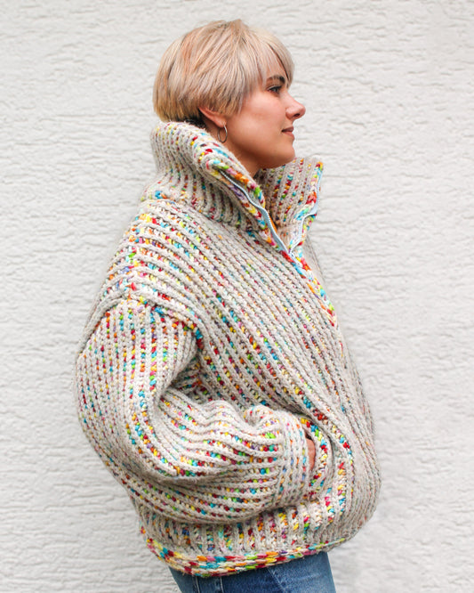 Pattern designer wearing a size MEDIUM Brioche Crochet Pullover in the fruity pebbles colorway, side view showing the drop-shoulder silhouette and brioche stitch texture.