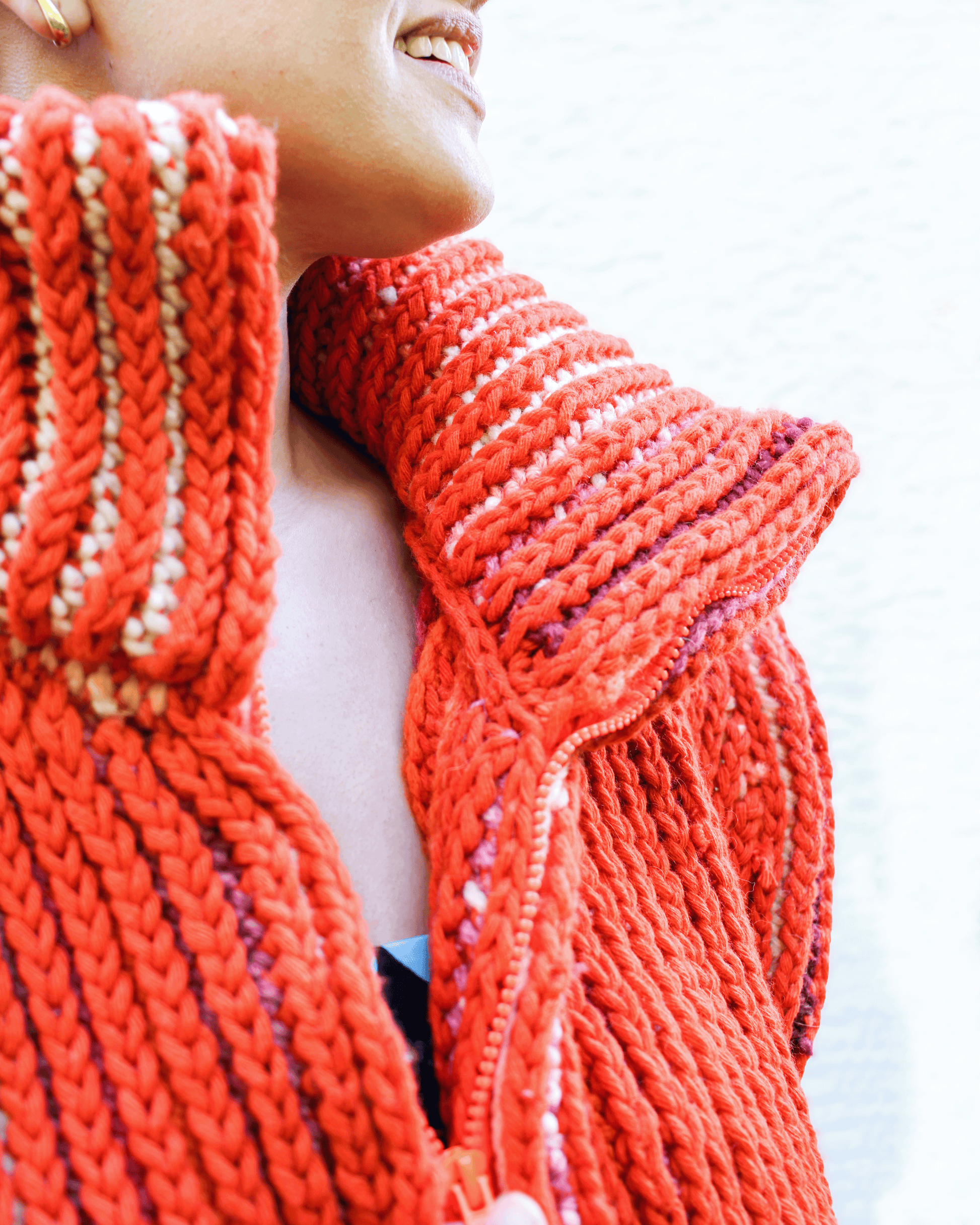 Brioche Crochet Vest — close-up of the chunky stand-collar, separating zipper hardware, and internal zipper facing that hides the zipper tape, in Sherbet colorway brioche stitch.