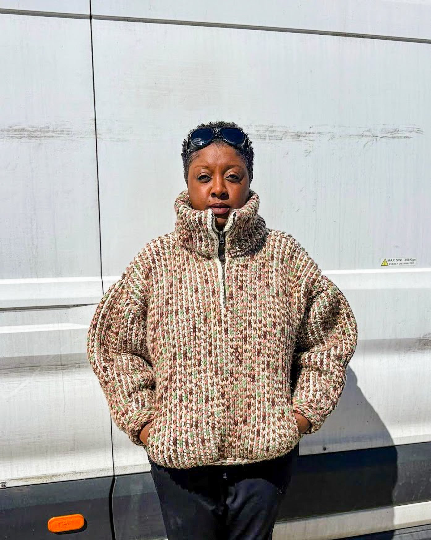 Pattern tester wearing a size Large Brioche Crochet Pullover in a green and brown multi colorway. Front view on a curvy  frame showing the relaxed drop-shoulder and oversized fit. 